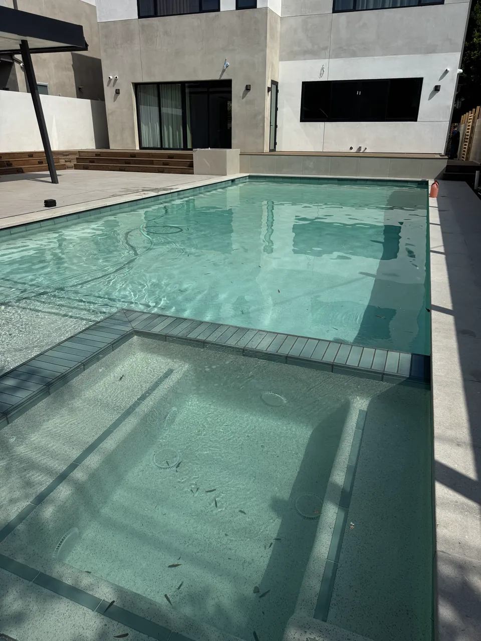 Spa steps and gray tile edging in clear water